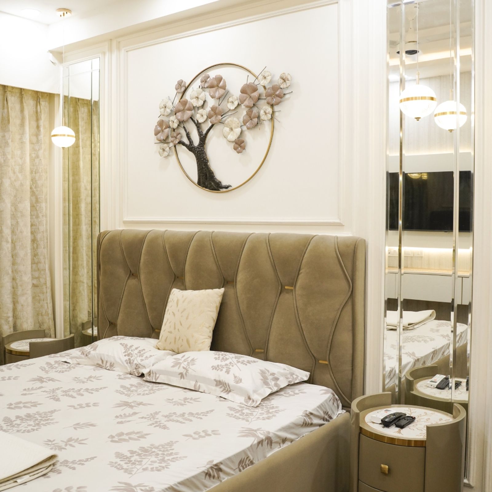 Master Bedroom Design with Beige Tufted Headboard, Floral Metal Wall Art, and Mirror Side Panels