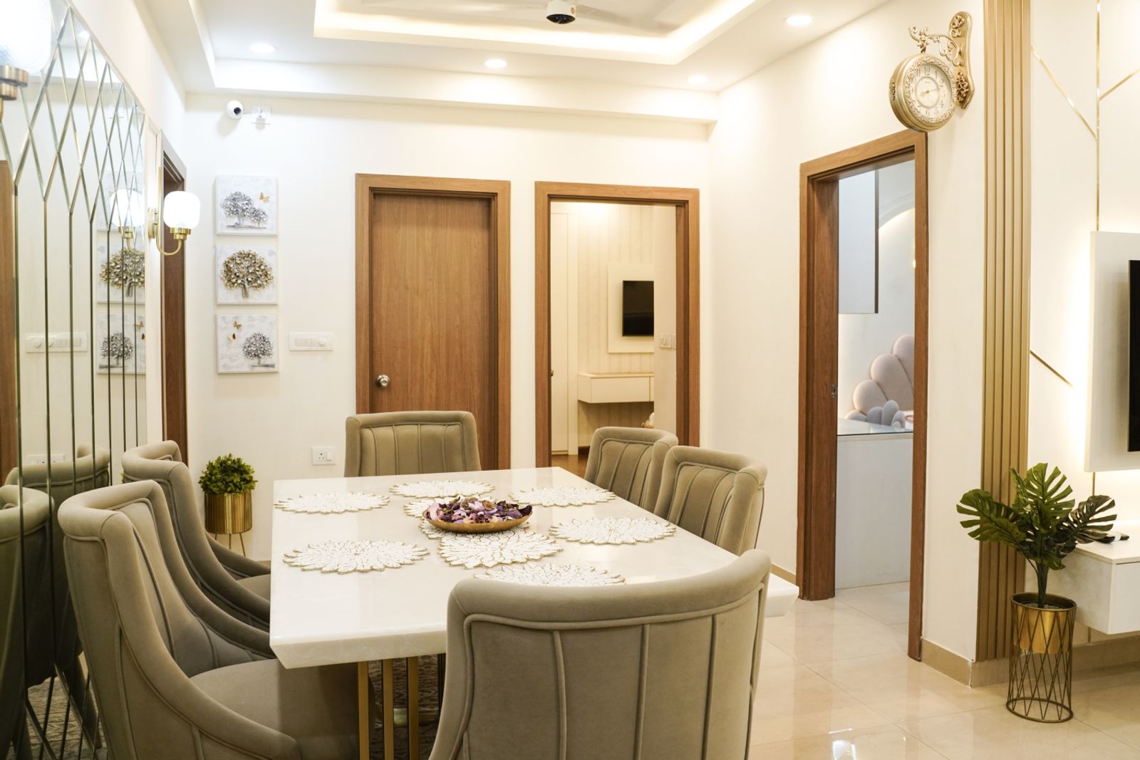 Dining Room Design with Grey Upholstered Chairs, Wall Mirrors, and Wooden Doors