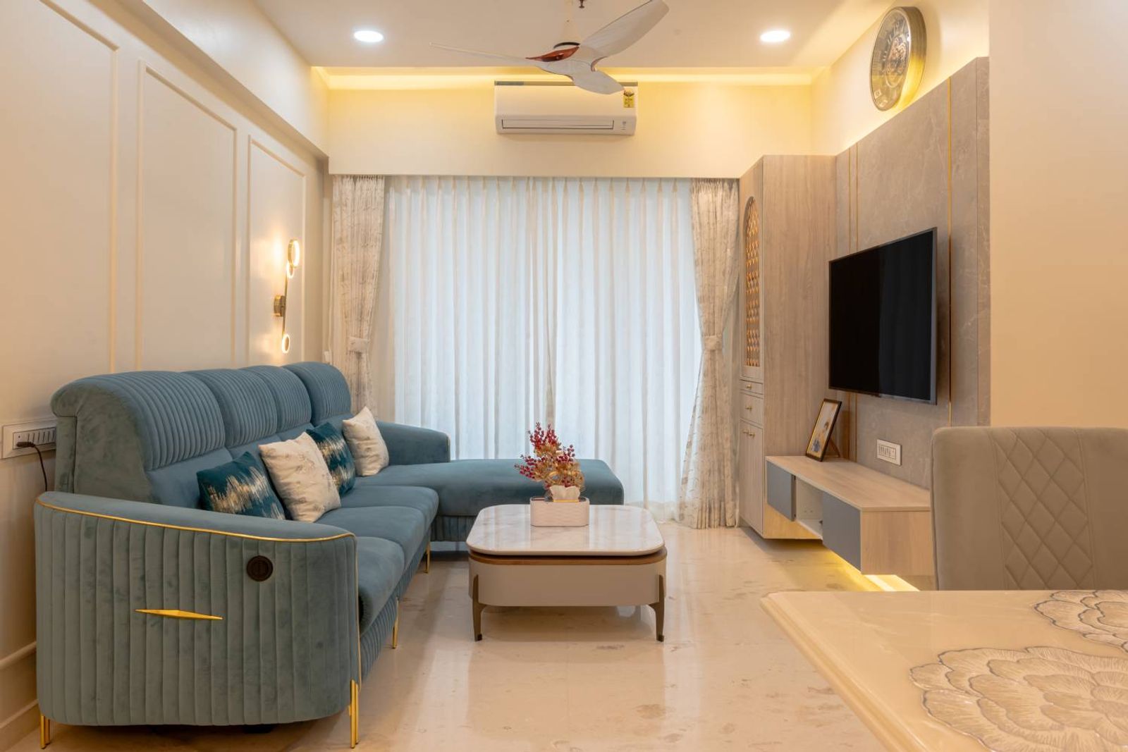 Living Room Design with Off-White Panelled Walls, TV Unit and Blue Sofa