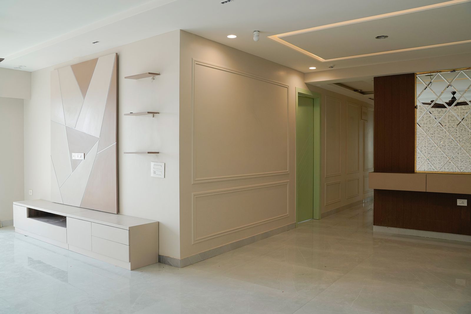 Living Room Design with Beige Wall with Trims, Beige and Brown TV Unit and Mirrored Wall
